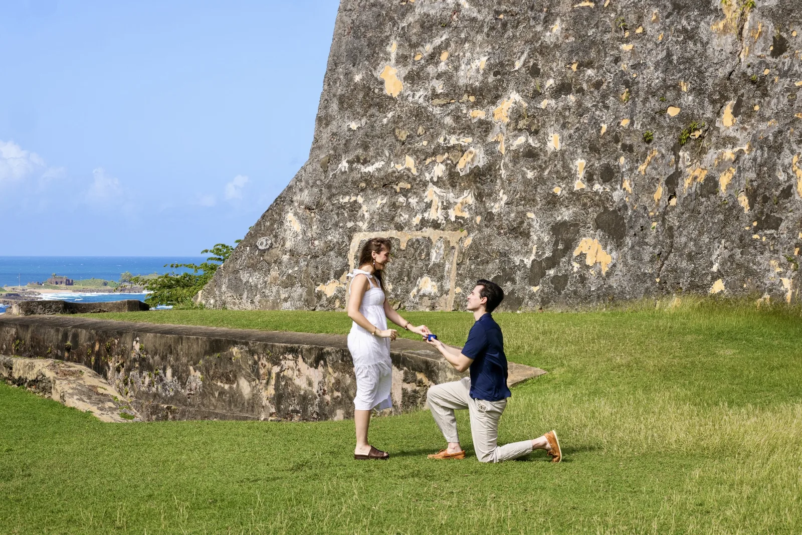 Couple at the moment of a surprise proposal at golden hour on a Puerto Rico beach